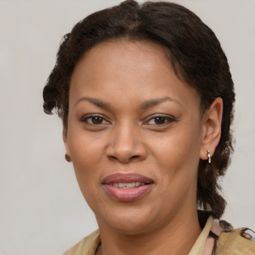 Joyful black adult female with short  brown hair and brown eyes
