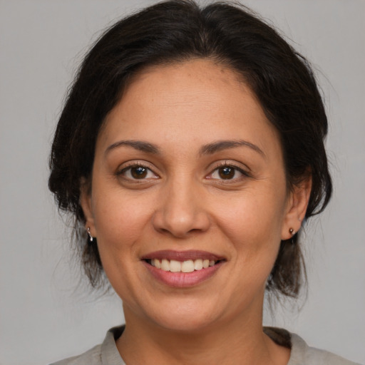 Joyful white adult female with medium  brown hair and brown eyes