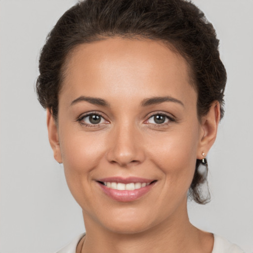 Joyful white young-adult female with short  brown hair and brown eyes