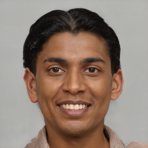 Joyful latino young-adult male with short  brown hair and brown eyes