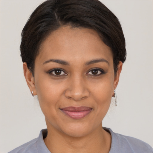 Joyful latino young-adult female with short  brown hair and brown eyes