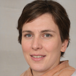 Joyful white adult female with medium  brown hair and brown eyes