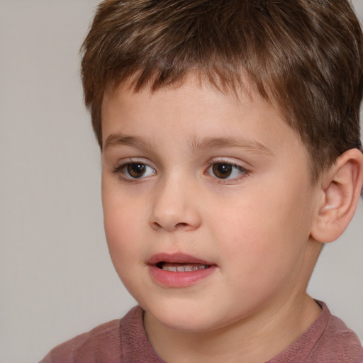 Joyful white child male with short  brown hair and brown eyes