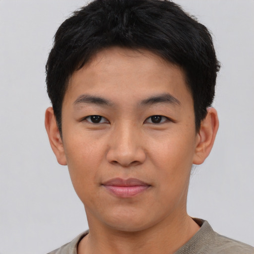 Joyful asian young-adult male with short  black hair and brown eyes