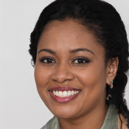 Joyful black young-adult female with long  brown hair and brown eyes