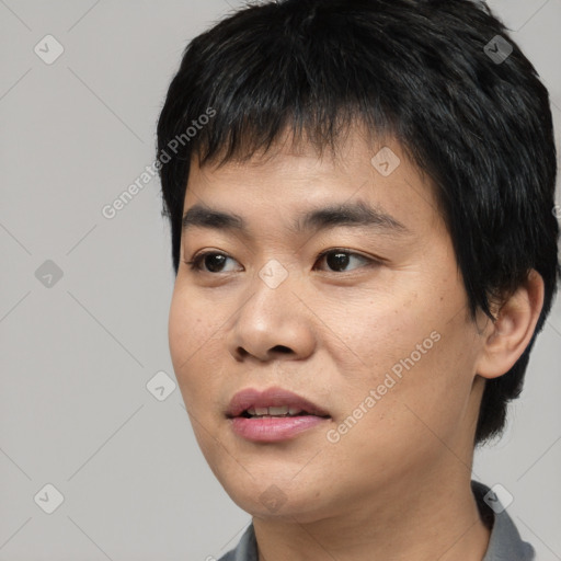 Joyful asian young-adult male with short  black hair and brown eyes