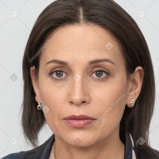 Joyful white adult female with long  brown hair and brown eyes