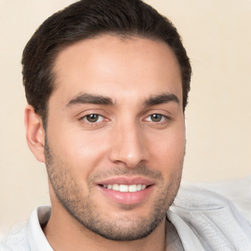 Joyful white young-adult male with short  brown hair and brown eyes