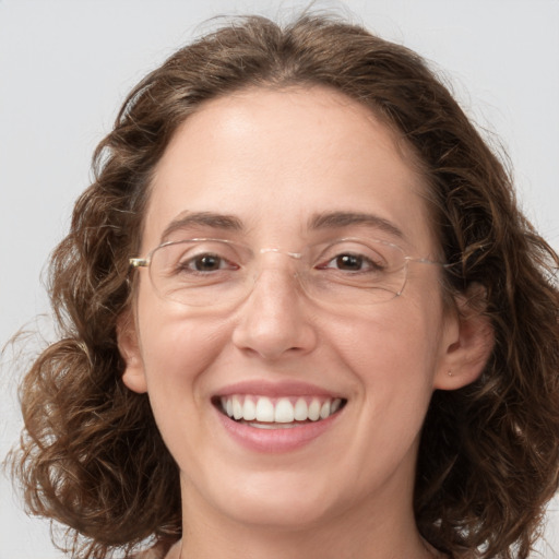 Joyful white adult female with medium  brown hair and green eyes