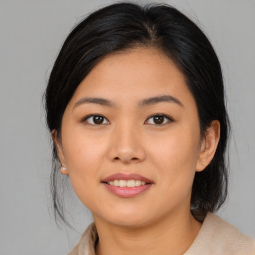 Joyful asian young-adult female with medium  black hair and brown eyes
