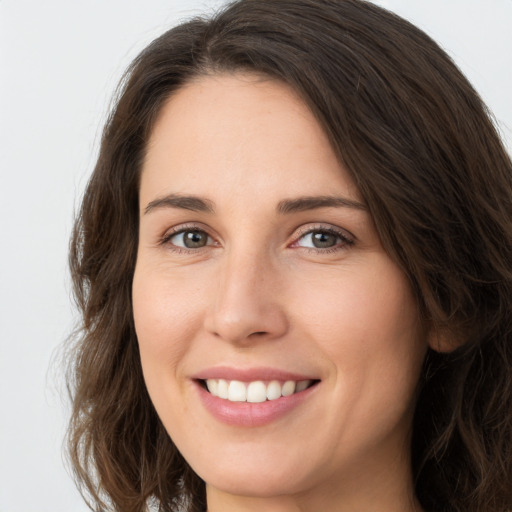 Joyful white young-adult female with long  brown hair and green eyes