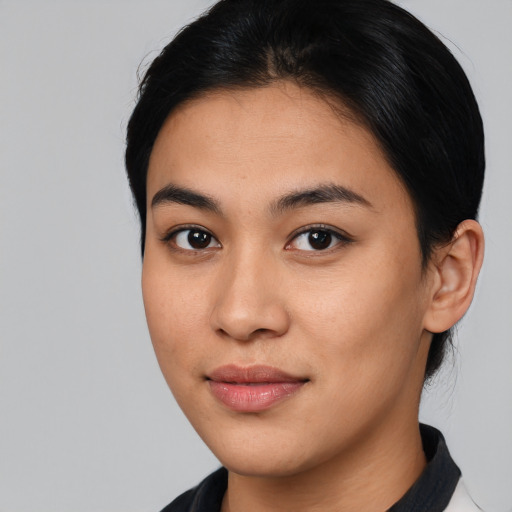 Joyful latino young-adult female with medium  brown hair and brown eyes