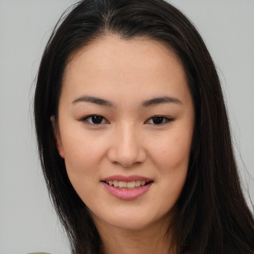 Joyful asian young-adult female with long  brown hair and brown eyes