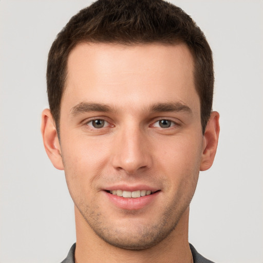 Joyful white young-adult male with short  brown hair and brown eyes