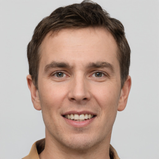 Joyful white young-adult male with short  brown hair and brown eyes