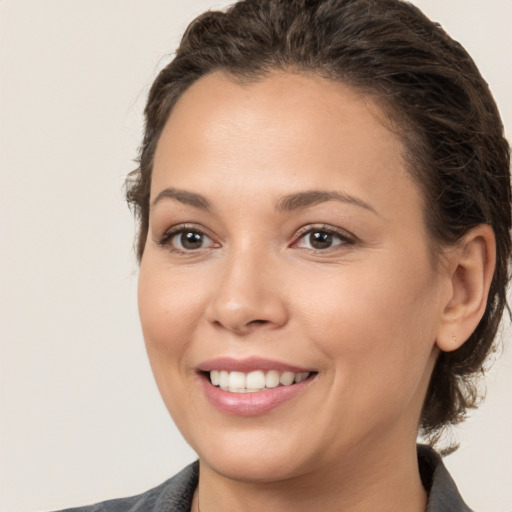 Joyful white young-adult female with medium  brown hair and brown eyes