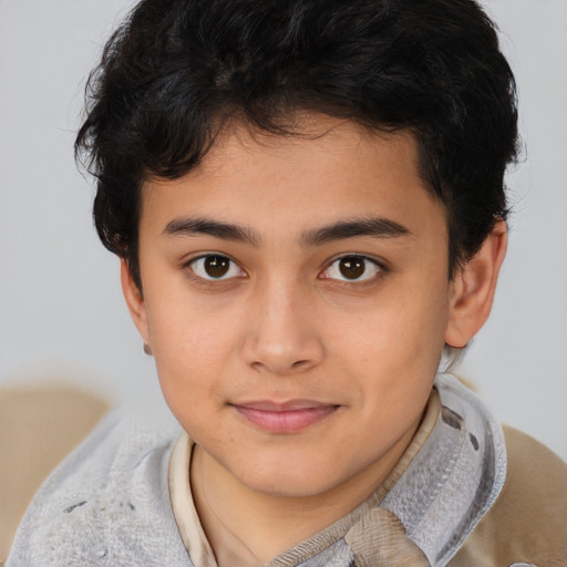 Joyful latino child male with short  brown hair and brown eyes