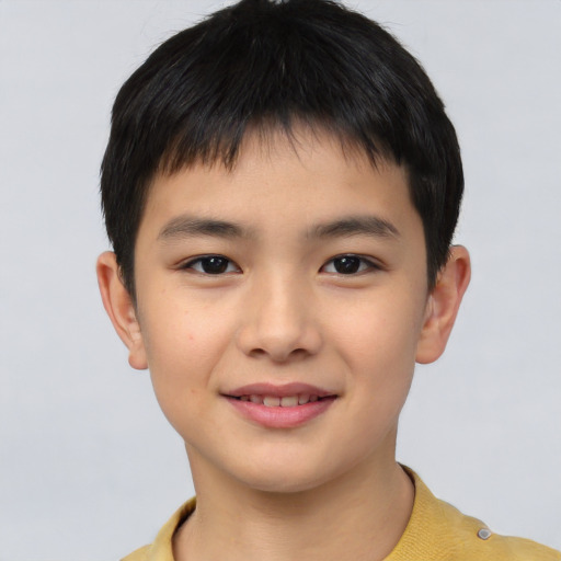 Joyful asian child male with short  brown hair and brown eyes