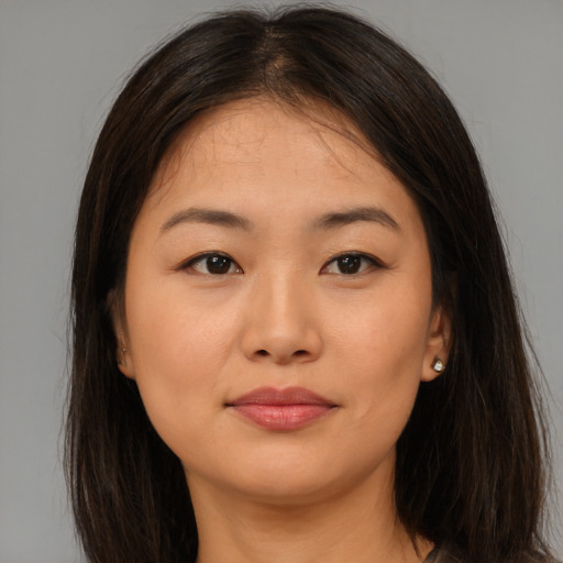 Joyful asian young-adult female with long  brown hair and brown eyes