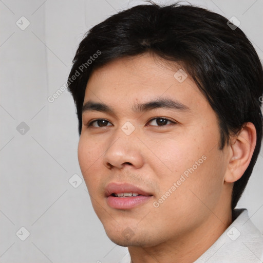 Joyful asian young-adult male with short  black hair and brown eyes