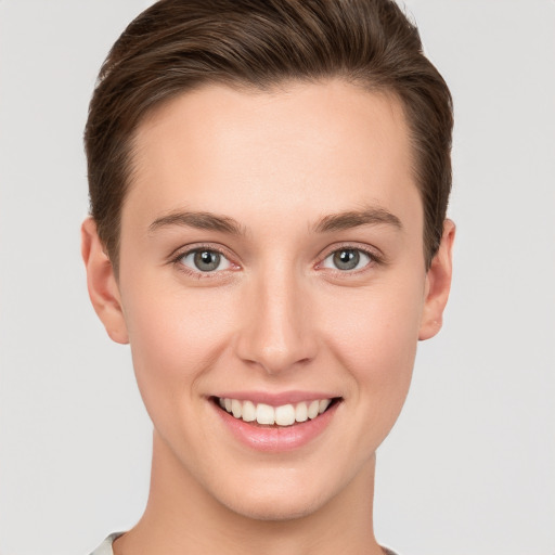 Joyful white young-adult female with short  brown hair and grey eyes