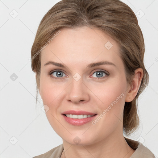 Joyful white young-adult female with medium  brown hair and blue eyes