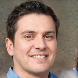 Joyful white adult male with short  brown hair and brown eyes