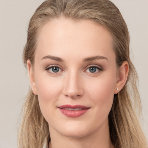 Joyful white young-adult female with long  brown hair and grey eyes