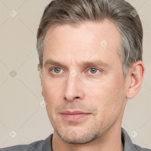 Neutral white adult male with short  brown hair and grey eyes