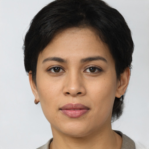 Joyful latino young-adult female with short  brown hair and brown eyes