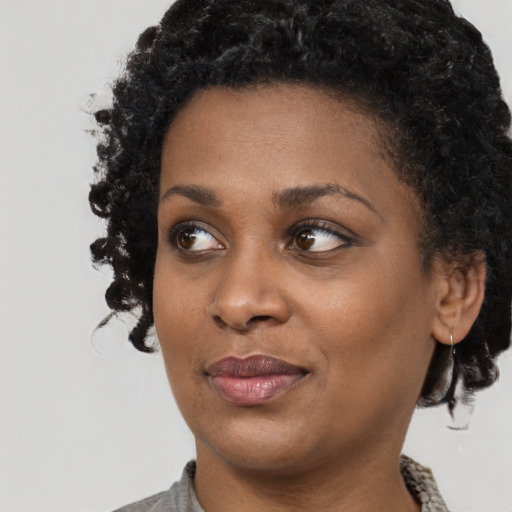 Joyful black young-adult female with medium  black hair and brown eyes