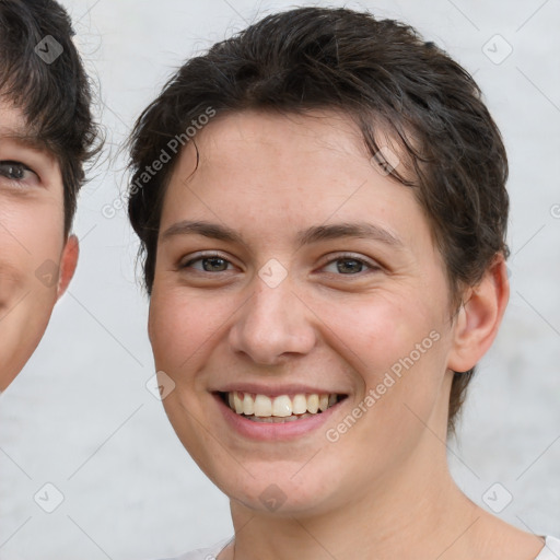 Joyful white young-adult female with short  brown hair and brown eyes