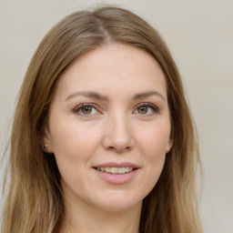 Joyful white young-adult female with long  brown hair and green eyes