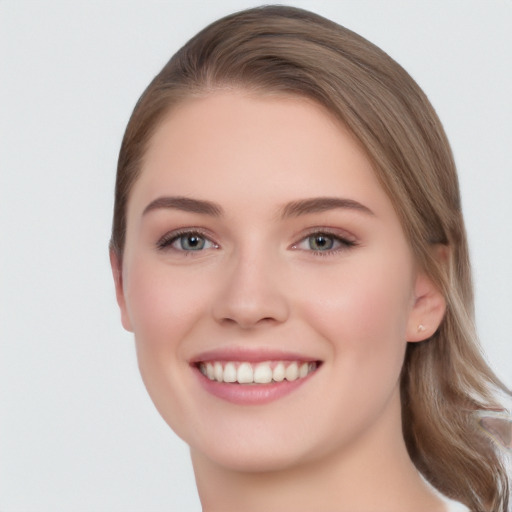 Joyful white young-adult female with long  brown hair and grey eyes