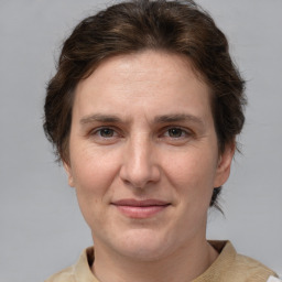 Joyful white adult female with short  brown hair and brown eyes