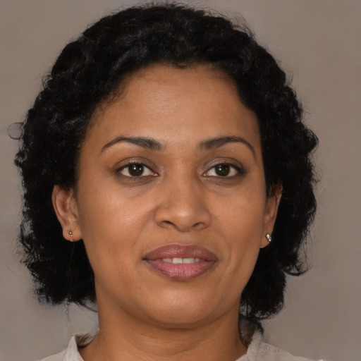 Joyful latino adult female with short  brown hair and brown eyes