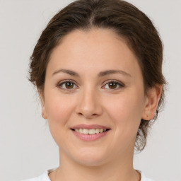 Joyful white young-adult female with medium  brown hair and brown eyes