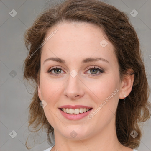 Joyful white young-adult female with medium  brown hair and green eyes