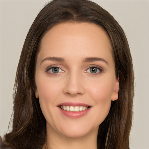 Joyful white young-adult female with long  brown hair and brown eyes