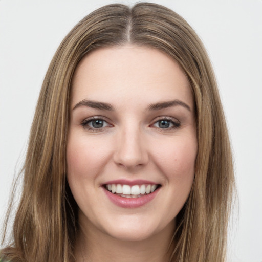 Joyful white young-adult female with long  brown hair and green eyes