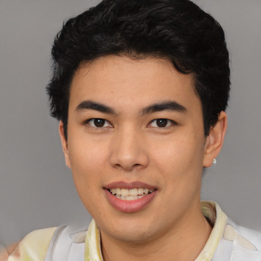 Joyful latino young-adult male with short  brown hair and brown eyes