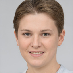 Joyful white young-adult female with short  brown hair and grey eyes