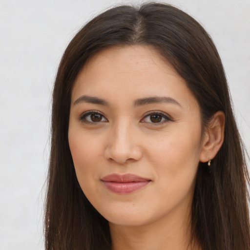 Joyful latino young-adult female with long  brown hair and brown eyes