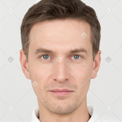 Joyful white young-adult male with short  brown hair and grey eyes