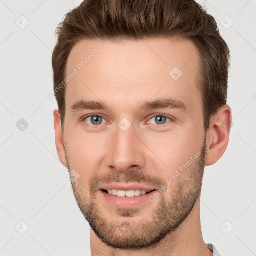 Joyful white young-adult male with short  brown hair and grey eyes