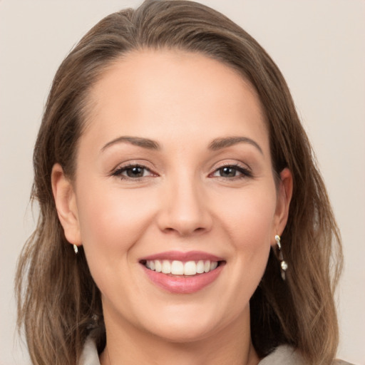 Joyful white young-adult female with long  brown hair and grey eyes