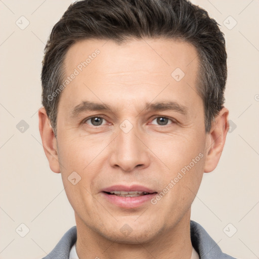 Joyful white adult male with short  brown hair and brown eyes