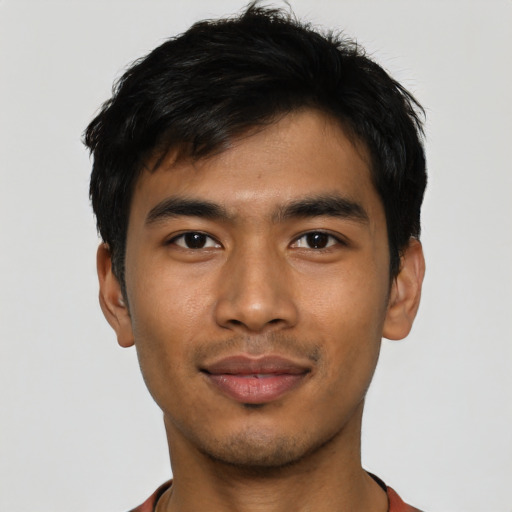 Joyful asian young-adult male with short  black hair and brown eyes