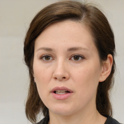 Joyful white adult female with medium  brown hair and brown eyes