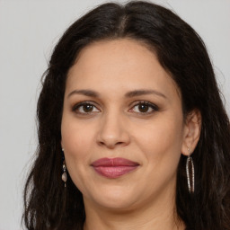 Joyful white adult female with long  brown hair and brown eyes